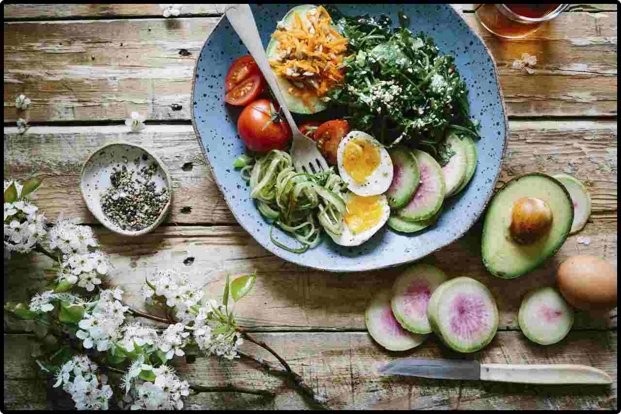 Fresh salad bowl with eggs mixed greens and vegetables